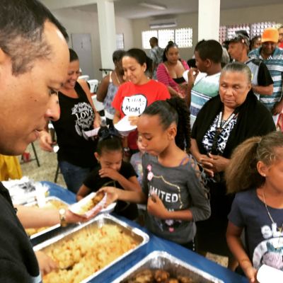 Yancey Arias serves food to the people of Puerto Rico.